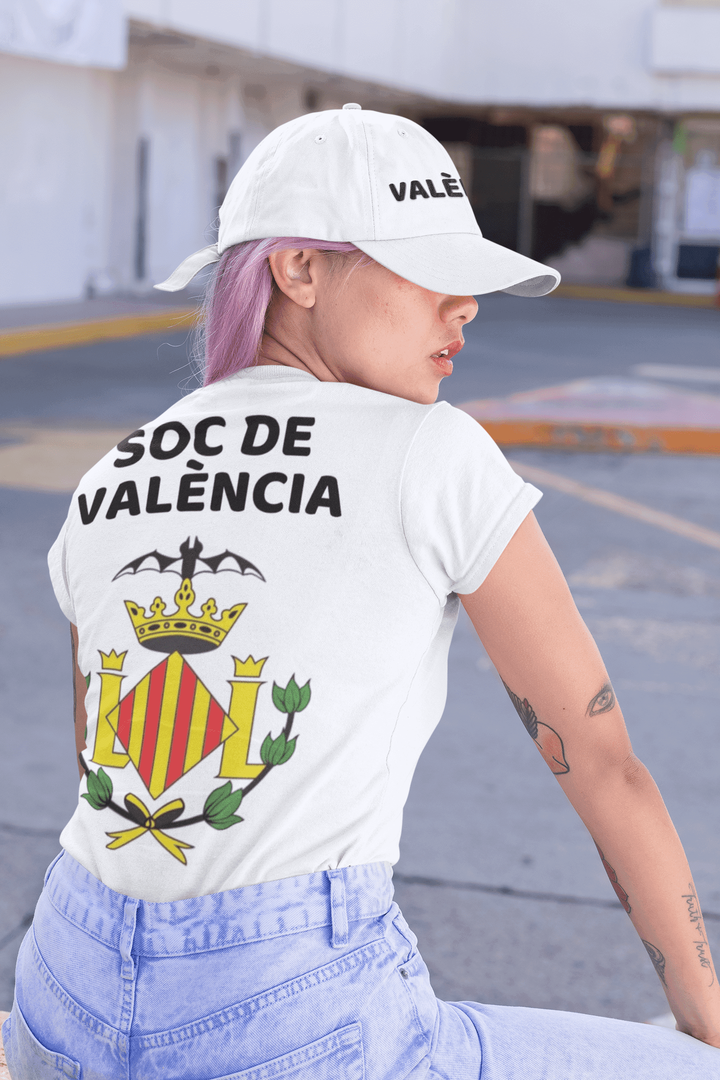 back view mockup of a woman wearing a customizable t shirt and a dad hat 31181